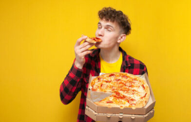 Guy eating pizza