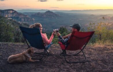 Couple-toasting-to-the-great-outdoors-while-lounging-in-their-camping-chairs-500x320