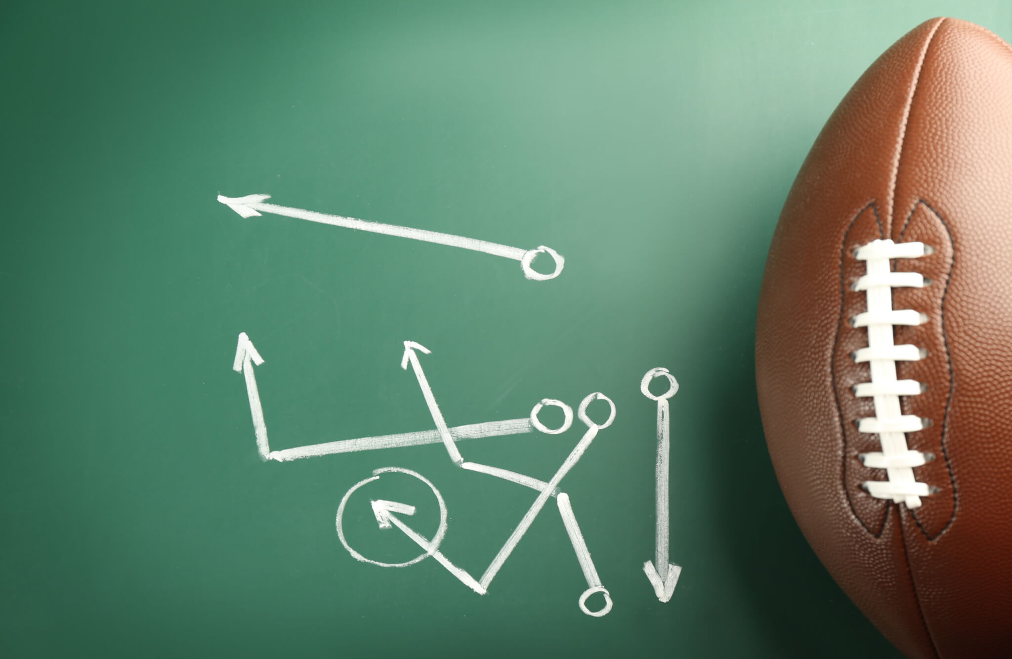 Football coach plays written on a chalkboard