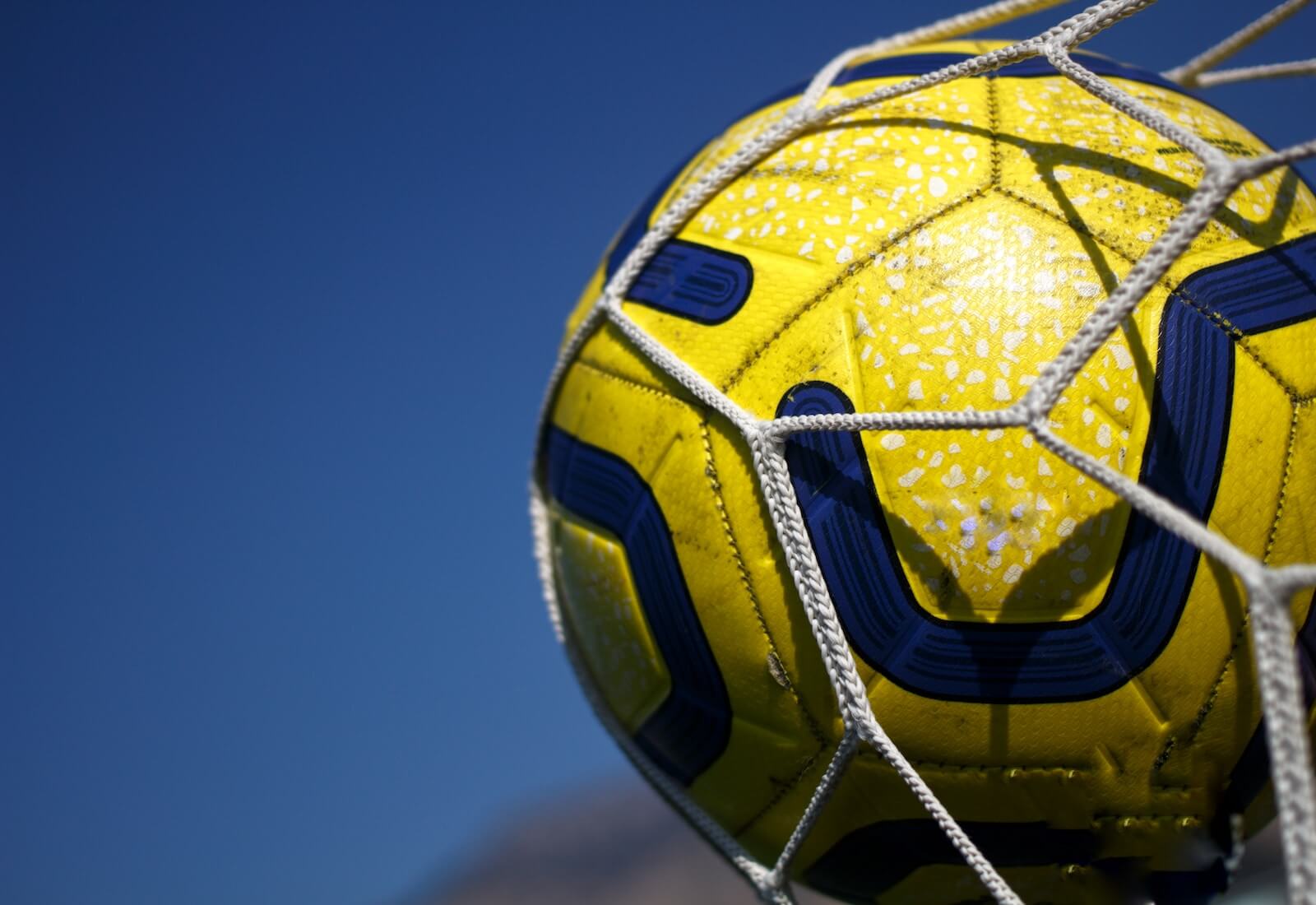 A soccer ball hitting a goal net