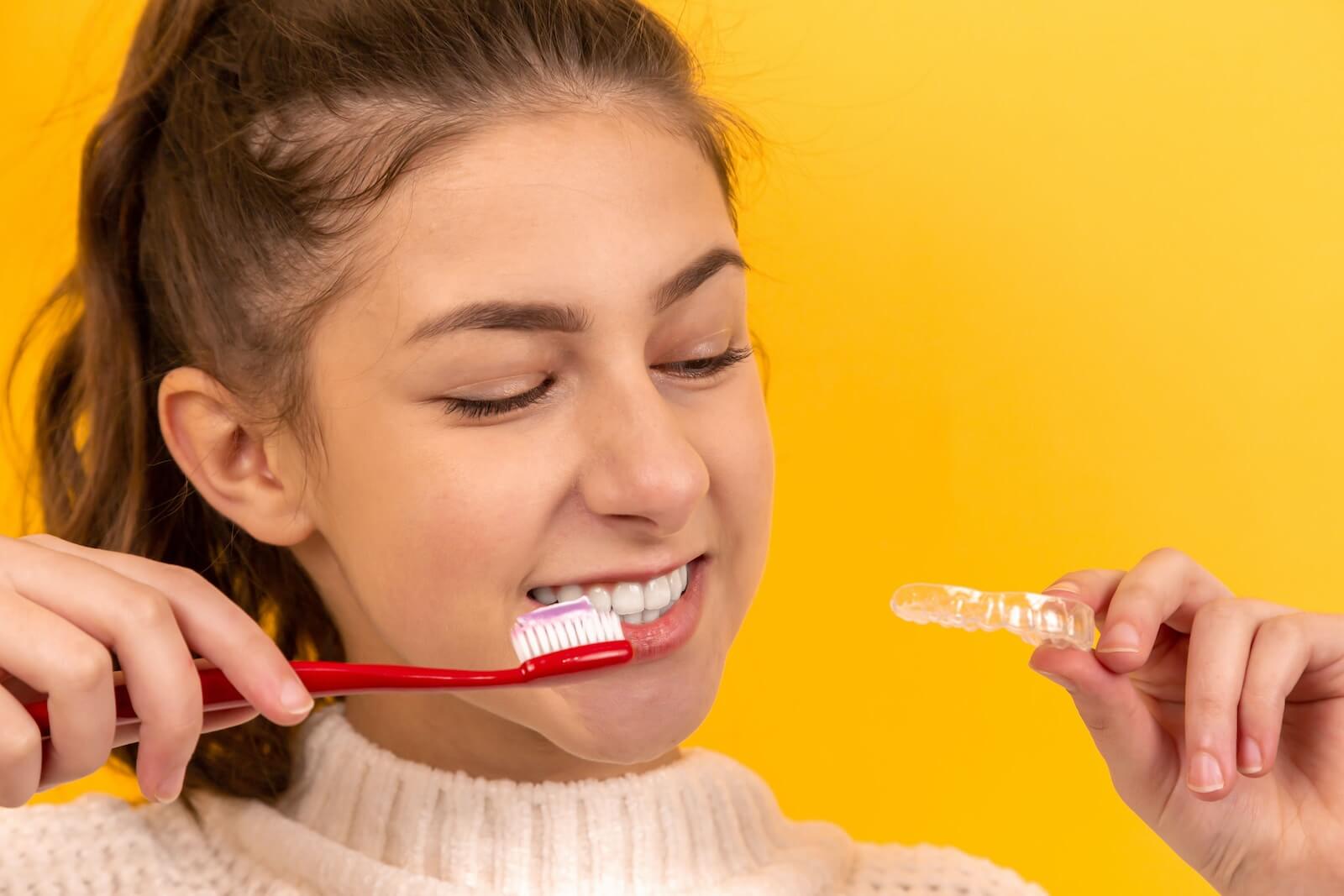A girl brushing teeth before whitening