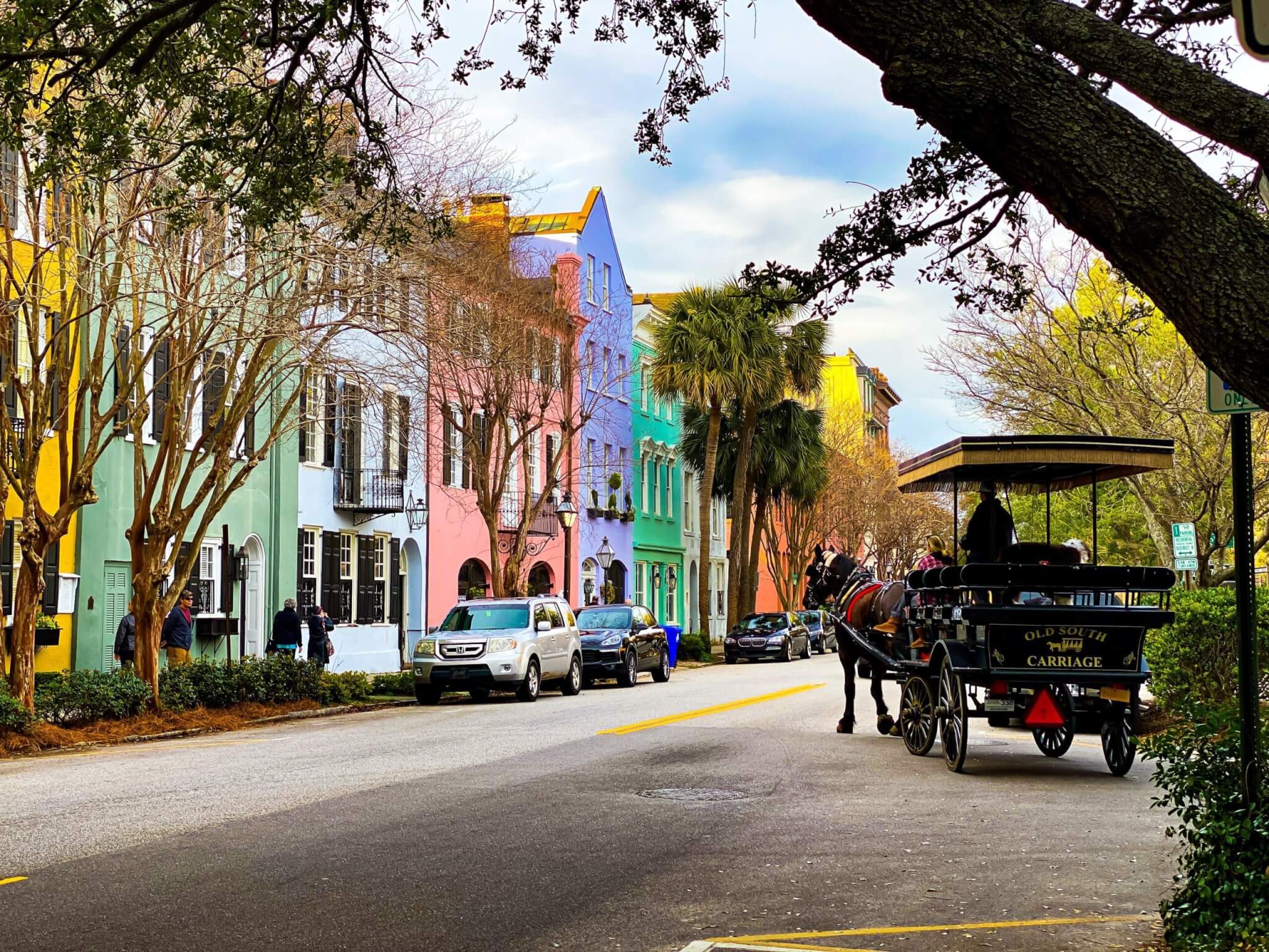 Rainbow Row in Charleston with a horse-drawn carriage