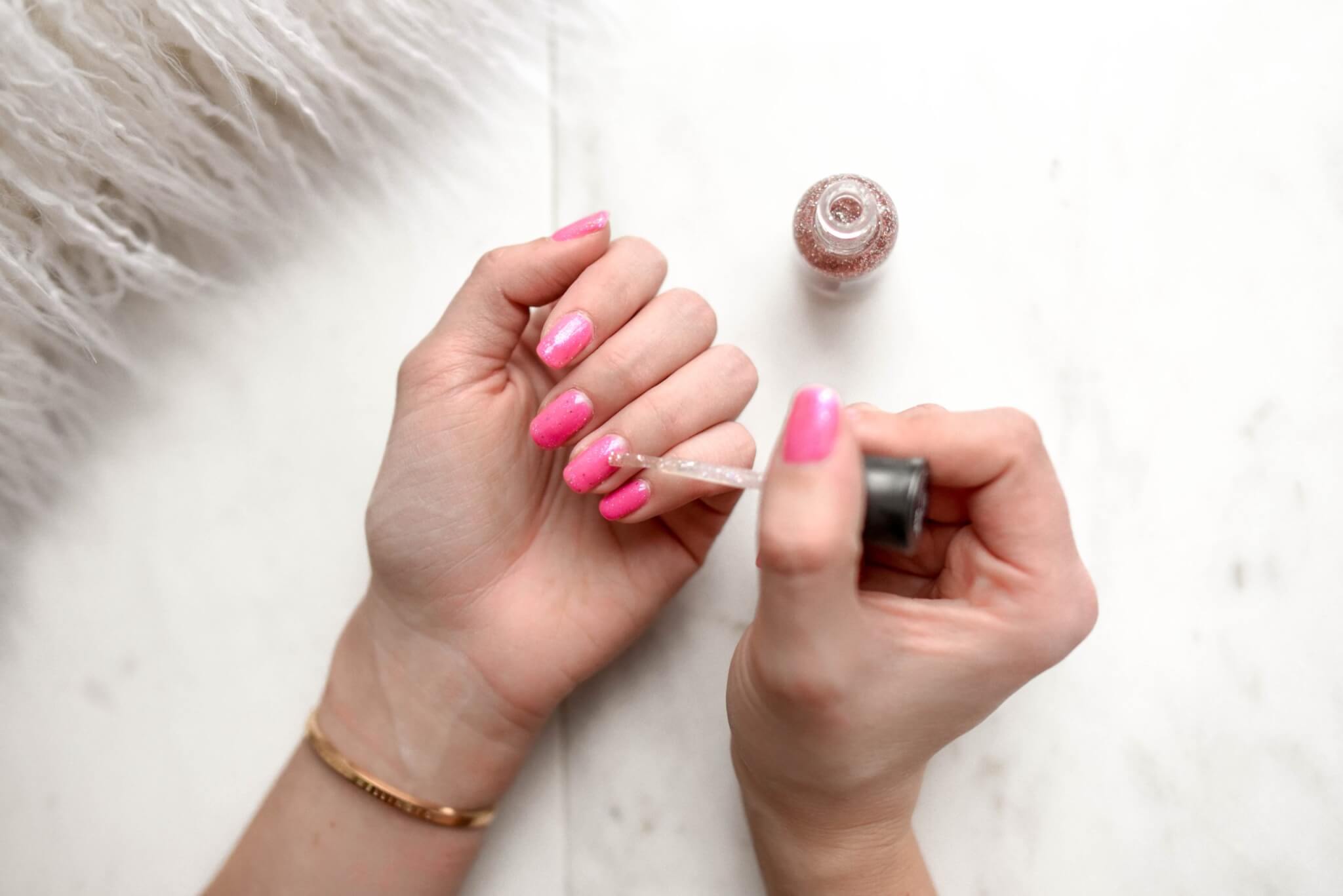 Woman painting her nails, giving herself a manicure